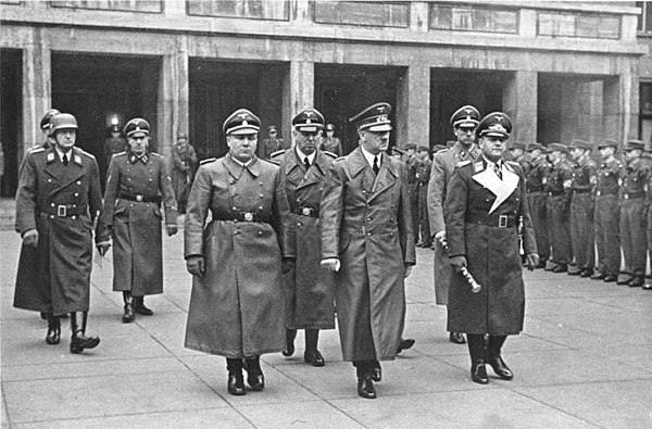 Brandt at right, following Hitler and Martin Bormann and walking behind Field Marshall Milch