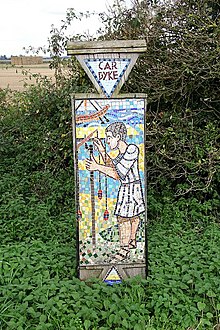 Car Dyke mosaic sign near Martin, Lincolnshire, showing a surveyor using a groma.