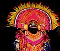Chhau dancer with demon mask performing at night
