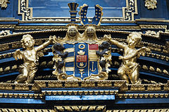 Golden image of cherubs flanking the Royal Coat of Arms, Church of the Infant Jesus of Prague