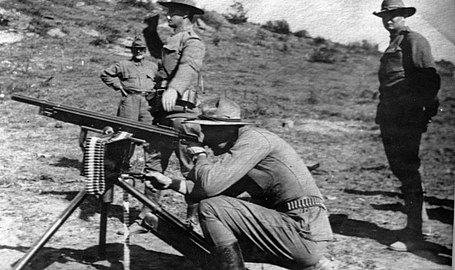 Colorado National Guard using a tripod-mounted automatic rifle.