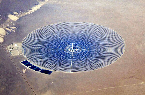 A solar power tower at Crescent Dunes Solar Energy Project concentrating light via 10,000 mirrored heliostats spanning thirteen million sq ft (1.21 km