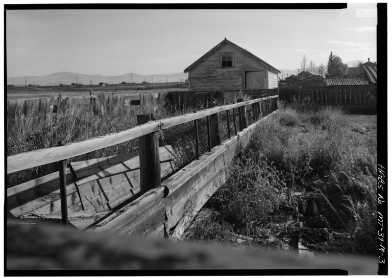 File:DISTANT VIEW OF REAR ELEVATION OF FEED STORAGE SHED WITH FEED RACKS IN FOREGROUND - Grant-Kohrs Ranch, Feed Lots, Storage Shed, and Feed Racks, Highway 10, Deer Lodge, Powell HABS MONT,39-DELO,1-M-3.tif