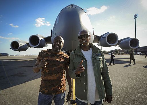 Chappelle (right) and Donnell Rawlings (left) stand in front of a C-17 Globemaster III at Joint Base Charleston, S.C. (2017)