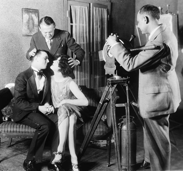 Goulding helping position actors for a kiss while making a film with the motion picture class at Columbia University in 1927