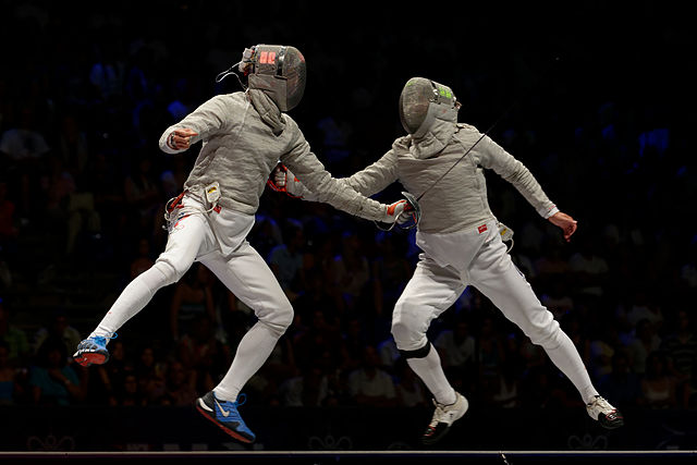 Veniamin Reshetnikov (Left) and Nikolay Kovalev (Right) hit each other simultaneously: both lights on the masks are on. Final of the 2013 World Fencin
