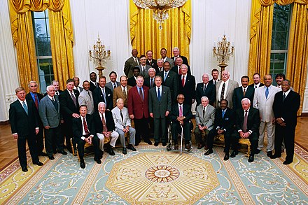 Will (at far left) with members of the Baseball Hall of Fame and George W. Bush at the White House in 2004