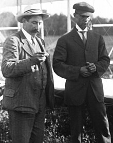 Hart O. Berg (left),[lower-alpha 4] the Wrights' European business agent, and Wilbur at the flying field near Le Mans.