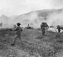 Indian troops of "Y" Company, 1st Battalion, 5th Mahratta Light Infantry, advancing under cover of smoke across the aerodrome. Wrecked planes and hangars can be seen through the smoke. Aquino, Italy, 25 May 1944. Indian troops advance across the Aquino aerodrome 1944.jpg