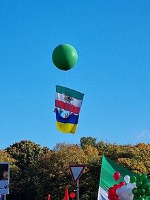 Flag of Iran's Lion and Sun intertwined with a flag of Ukraine, flown at an Iranian anti-Islamic Republic rally in the city of Berlin, October 2022 Iran solidairty protests 22 October 2022 in Berlin 04.jpg