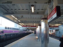 The Red Line MBTA platform at the JFK/UMass station with a commuter rail at the station (2007)