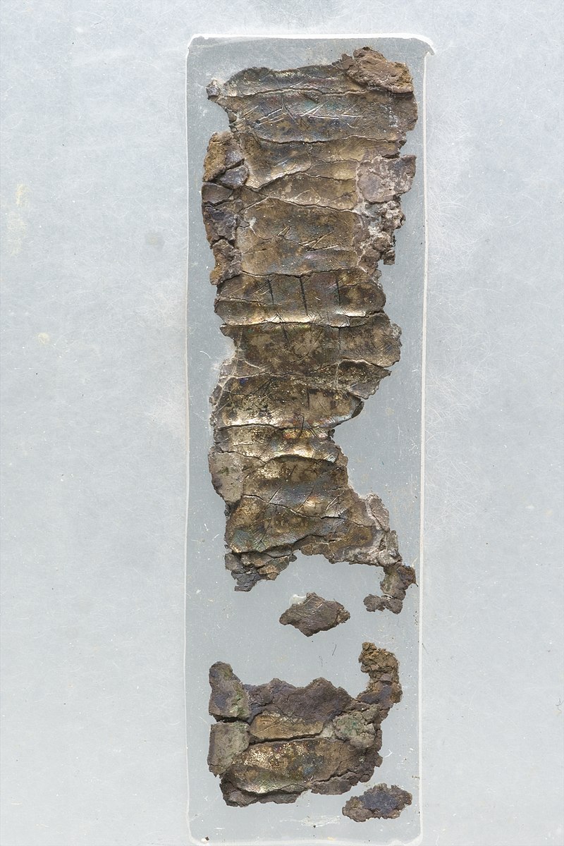 Image of a broken up metal ancient amulet