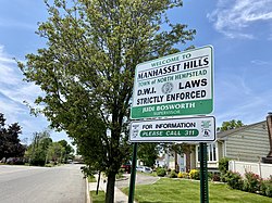 A welcome sign to Manhasset Hills, located at the intersection of Old Courthouse Road and Shelter Rock Road.