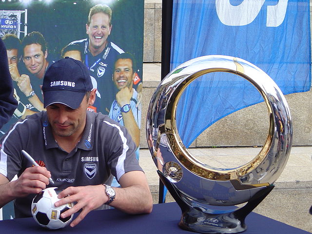 Inaugural captain Kevin Muscat in 2007 with the A-League championship trophy, who would lead Melbourne to success as a captain and later manager.