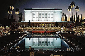 View of temple and reflecting pond between temple and visitor center, a night with Christmas lights lit