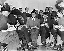 Welles takes questions from reporters at a press conference the day after the broadcast, on October 31, 1938 Orson Welles 1938 War of the Worlds.jpg