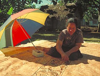 A Tongan woman accentuating the kupesi design Paint ngatu.jpg