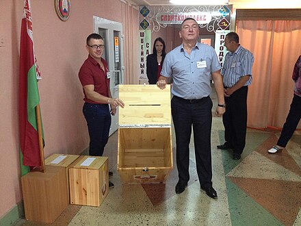 Members of a commission showing empty ballot box before its closure, Slutsk Parliamentary elections in Belarus 2016, 63.jpg