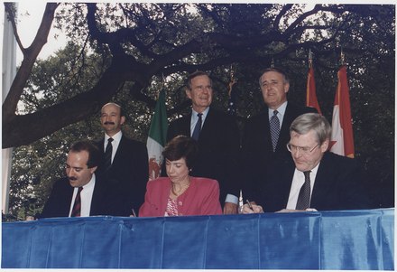 U.S. President Bush, Canadian PM Mulroney, and Mexican President Salinas participate in the ceremonies to sign the North American Free Trade Agreement (NAFTA).