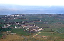 An aerial view of Eastchurch village, a caravan site, the three prisons and the North Sea Prisons isle of-sheppey.jpg