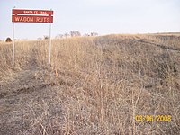 To the right of the sign are remnants of wagon ruts left from the Santa Fe Trail in the Ivan Boyd Prairie Preserve near Baldwin City. Also was the site of Black Jack.