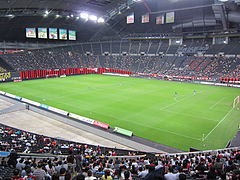 Soccer field installed inside the stadium, during a football match.