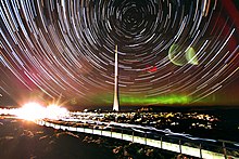 Star trail photographed from Mount Wellington, Tasmania. Aurora australis visible in the background. Star trail and aurora over Mount Wellington, Tasmania.jpg