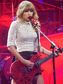 Taylor Swift singing "Red" over an electric guitar