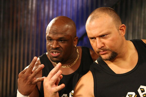 D-Von and Bubba Ray making the 3D taunt (index finger and thumb forming the lower part of a 'd', the middle finger forming the upper part of the 'd' w