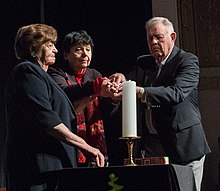 Holocaust survivors light a memorial candle with a concentration camp liberator at a remembrance ceremony, Washington DC, 2013. Theresienstadt Concentration Camp Czech Jewish Holocaust Survivor Ela Stein-Weissberger, German Jewish Holocaust Survivor Inge Auerbacher; and Dachau Concentration Camp Liberator Jimmy Gentry.jpg