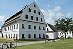 A complex of paper mill buildings with white facades