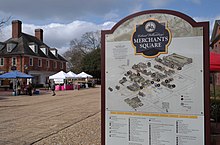 A view of the Farmers' Market in Merchant's Square in Colonial Williamsburg with map in foreground Williamsburg Farmers' Market 2.jpg