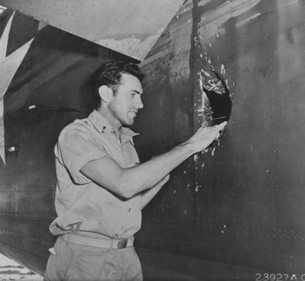 Zamperini examines a hole in his B-24D Liberator Super Man made by a 20 mm shell over Nauru.