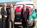 Mr Geraint Williams,Y Cyfarwyddwr Addysg, Dr Meirion Davies a Mr Arfon Williams gyda'r bws mini newydd a brynwyd yn ystod y dathlu.