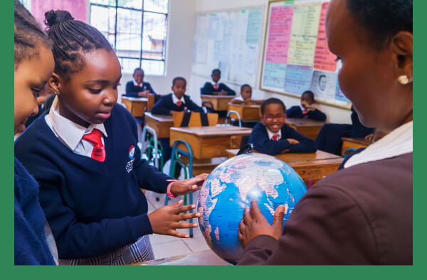 File:Teacher points to a globe green.jpg