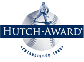 The words "HUTCH AWARD" in white on a navy blue rectangular background, placed in front of a baseball with a small baseball player on top of the baseball. Underneath the baseball reads "ESTABLISHED 1965"