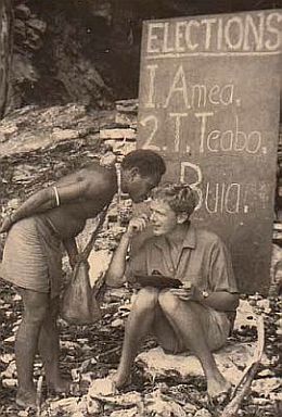 District officer Tony Hughes recording a whisper vote during the 1962 Malaita council election. The board behind him lists the candidates' names.