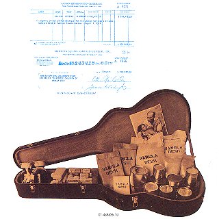 The album booklet's back cover, showing a cheque for the concerts' box-office takings above a guitar case packed with emergency supplies; copyright Apple Records