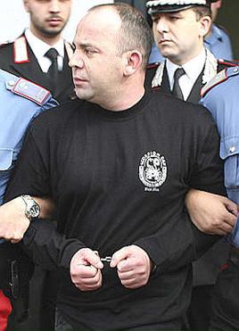 Italian police force escort Francesco Vottari following his arrest in San Luca Francesco Vottari.jpg