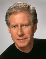 Publicity shot of a clean-shaven man with short, blond, and greying hair