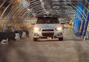 During the chorus sections of the song, Kulash drove the Sonic through a tunnel outfitted with several homemade instruments, including pipes, drums, hubcaps, and glass jars, with pneumatic arms and extensions from the car used to strike these to generate the video's music. OK-Go Needing-Getting.png