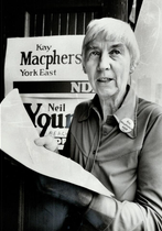 Kay Macpherson standing in front of a poster that states "Kay Macpherson York East NDP"