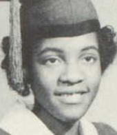 A smiling young Black woman wearing an academic cap and gown