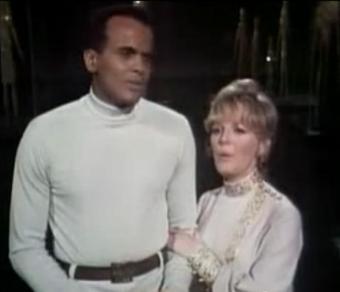 Clark holding Belafonte's arm