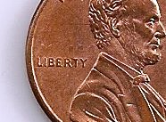 The marks seen above the word LIBERTY on this U.S. cent were caused by the obverse die clashing with elements on the reverse die intended to impress the space between the memorial columns in the design Die clash.jpg