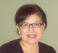 headshot of a woman with dark hair and glasses