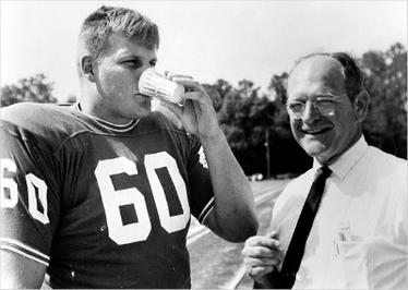 University of Florida football player Chip Hinton testing Gatorade 1965, pictured next to the leader of its team of inventors, Robert Cade.
