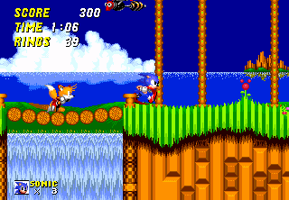 Sonic and Tails run around a loop and a corkscrew, and collect rings in the first level of Sonic the Hedgehog 2, a grassy area called Emerald Hill.