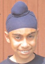 A Sikh boy with a rishi knot wearing a patka.