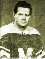 Black and white photo of a middle-aged man wearing a hockey jersey